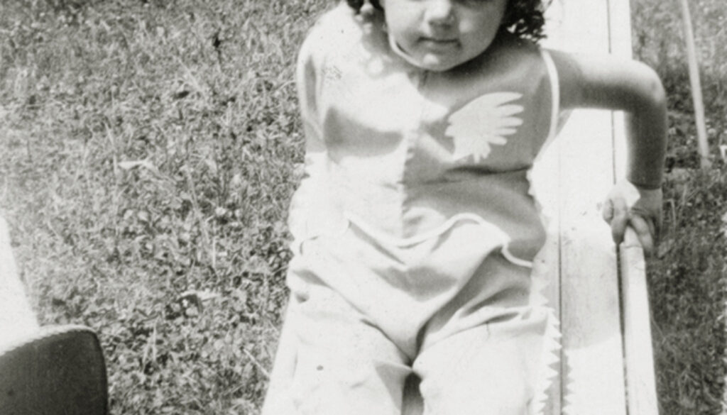 Shirley Schlanger as a child on a slide