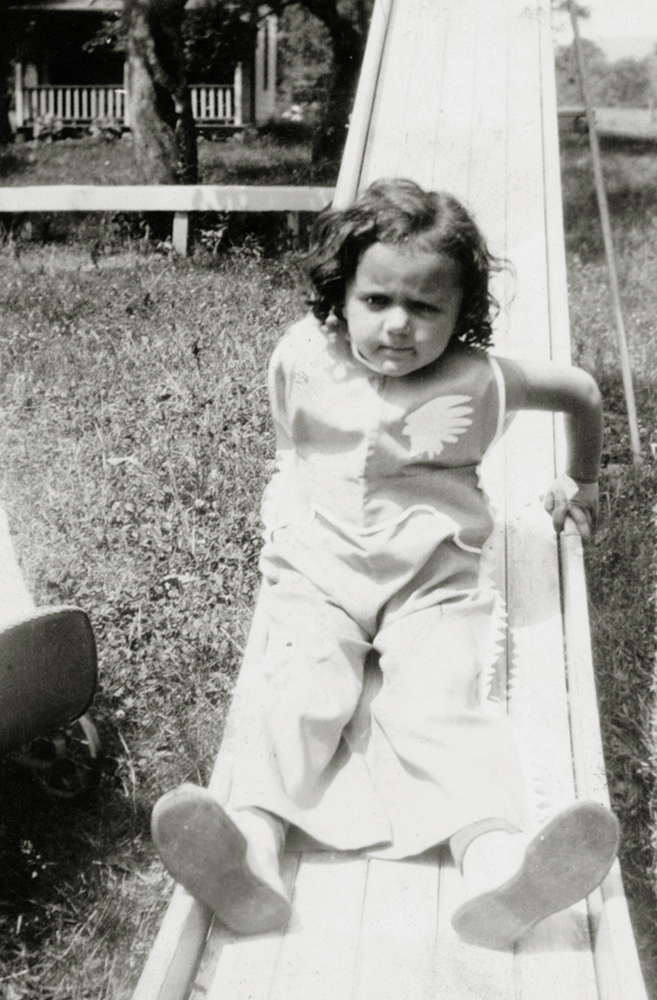 Shirley Schlanger as a child on a slide