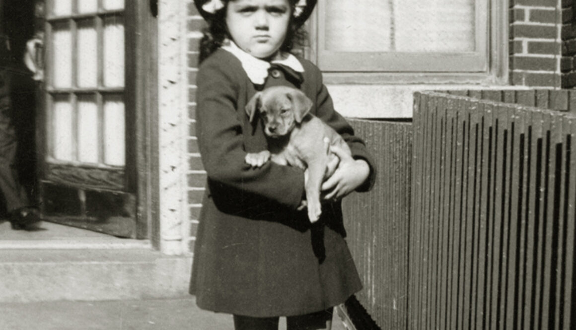 Shirley Schlanger as a child holding a puppy