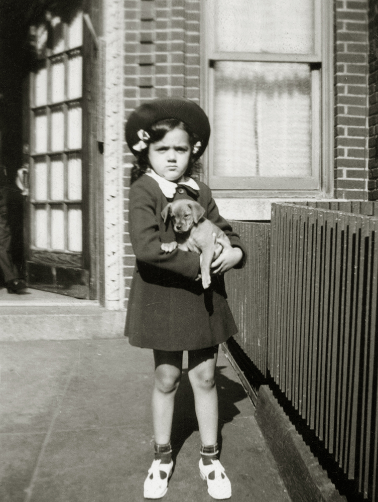 Shirley Schlanger as a child holding a puppy