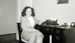 Shirley Schlanger at her desk with a typewriter