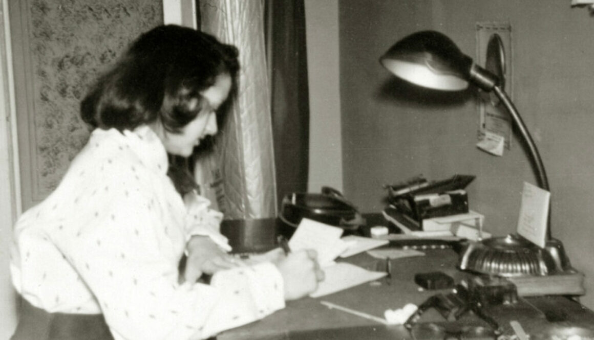 Shirley Schlanger writing at a desk