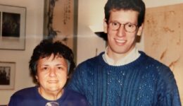 David Jacobs wearing a blue sweater over a white collared shirt is standing next to Justice Abrahamson who is wearing a purple top.