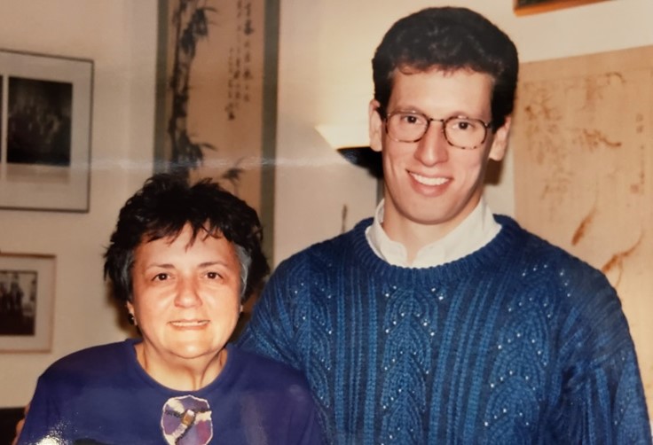 David Jacobs wearing a blue sweater over a white collared shirt is standing next to Justice Abrahamson who is wearing a purple top.